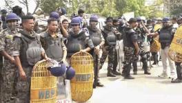 Security personnel stand guard after clashes between two groups at Jangipur, in Murshidabad district, Saturday, April 12, 2025.
