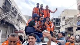 Emergency workers celebrate the announcement of a ceasefire deal. Photo: Screenshot