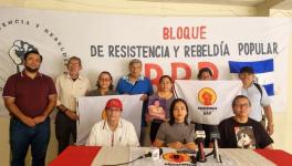 Organizers hold flags and a photo of labor martyr Febe Elizabeth Velasquéz during a press conference on the commemoration of the Day of the Salvadoran Trade Unionist. Photo: BRRP/X
