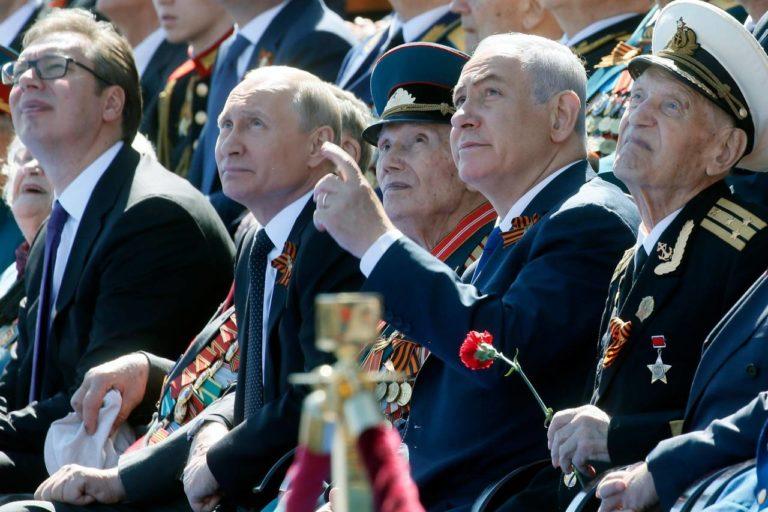 Russian President Vladimir Putin (second from left) and Israeli Prime Minister Benjamin Netanyahu watch the Victory Day military parade at Red Square, Moscow, May 9, 2018.