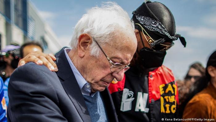 Christian Smalls dresses and speaks like a worker. Here he meets US Senator Bernie Sanders at a union rally.