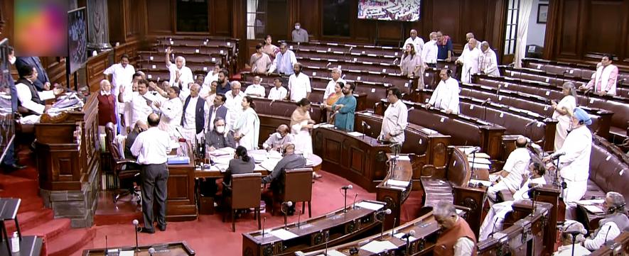 Opposition MPs shout slogans in the Well of Rajya Sabha while staging a protest over the price hike in fuel and essential commodities during the second part of the Budget Session of Parliament,