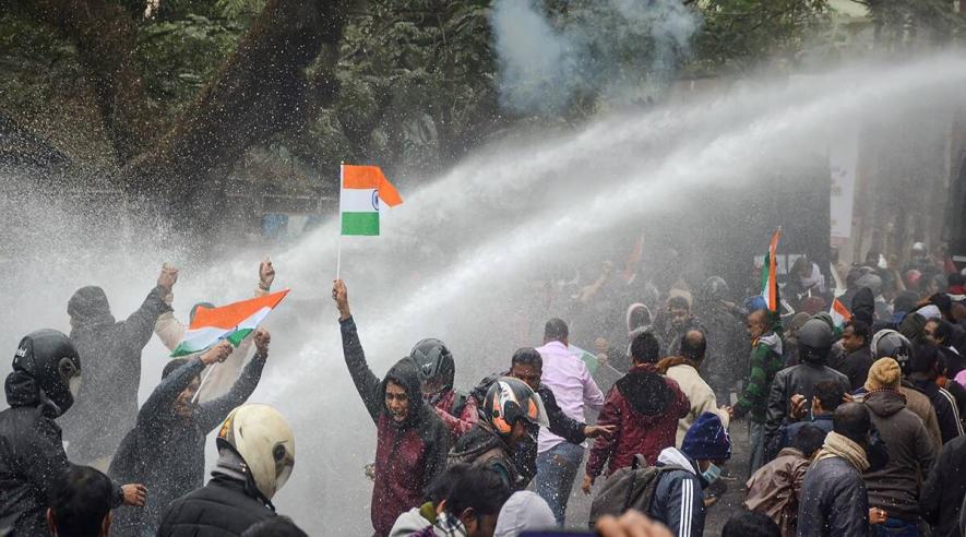 Police personnel use water cannons on teachers to disperse them during their protest, in Agartala, Wednesday