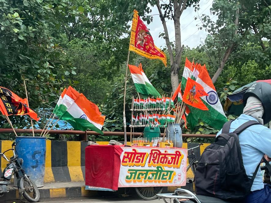 Indian flag along with the Ram Mandir Pran Pratishtha flag being sold on the main road near Guldhar Railway Station, Ghaziabad