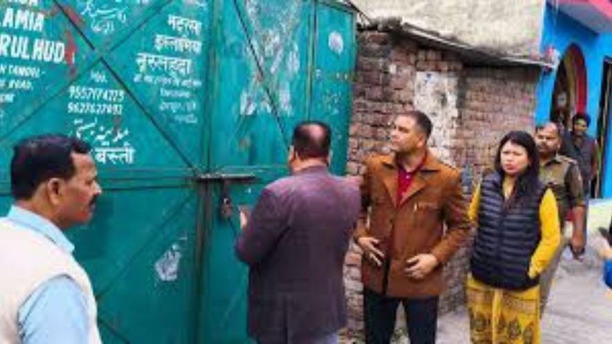Officials sealing a Madrassa in Uttarakhand.