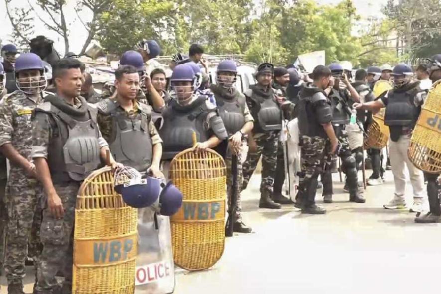 Security personnel stand guard after clashes between two groups at Jangipur, in Murshidabad district, Saturday, April 12, 2025.