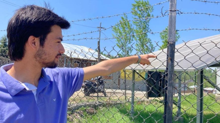 Shakir pointing towards solar panels (Photo - Arsalan Bukhari, 101Reporters)