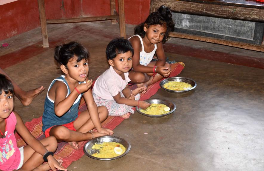 Children are eating cooked hot food at anAnganwadi centre in Kenduadihi, Bankura.