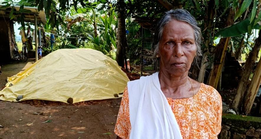 Ammini Chacko standing in front of a truckload of mud bought by a resident for filling puddles (Photo - Nisha Matamp, 101Reporters)
